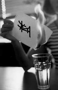 burning calligraphy above a glass of water
